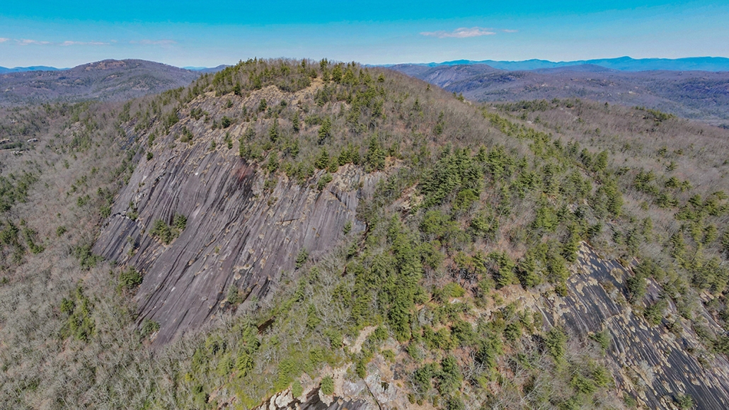 An aerial view of Rock Mountain with Chimney Top in the background.