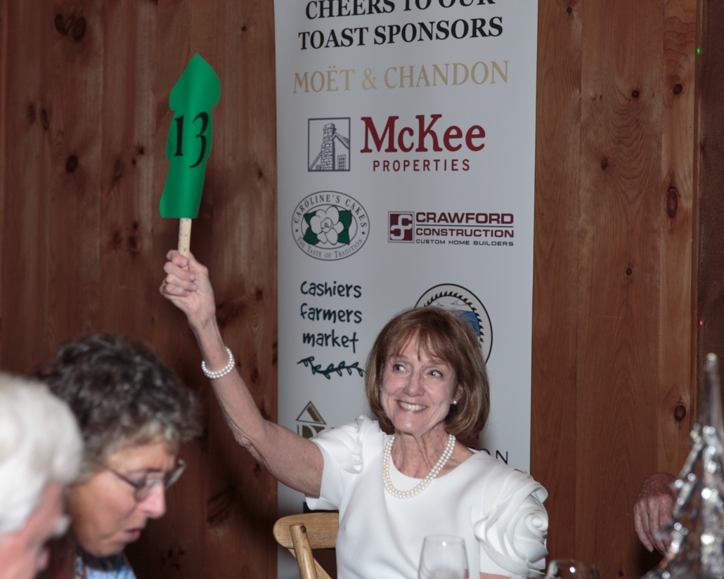 Guests enjoyed a brief albeit thrilling live auction. Pictured here is Carol Hunter, who with her husband Rob Hunter, led the committee for Toast of the Trees. 