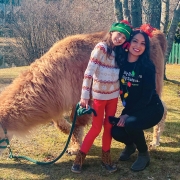 Little Sister Kira and Big Sister Karla Magana-Almanza at the 2021 Highlands Christmas parade with the llamas of Llama Caddy