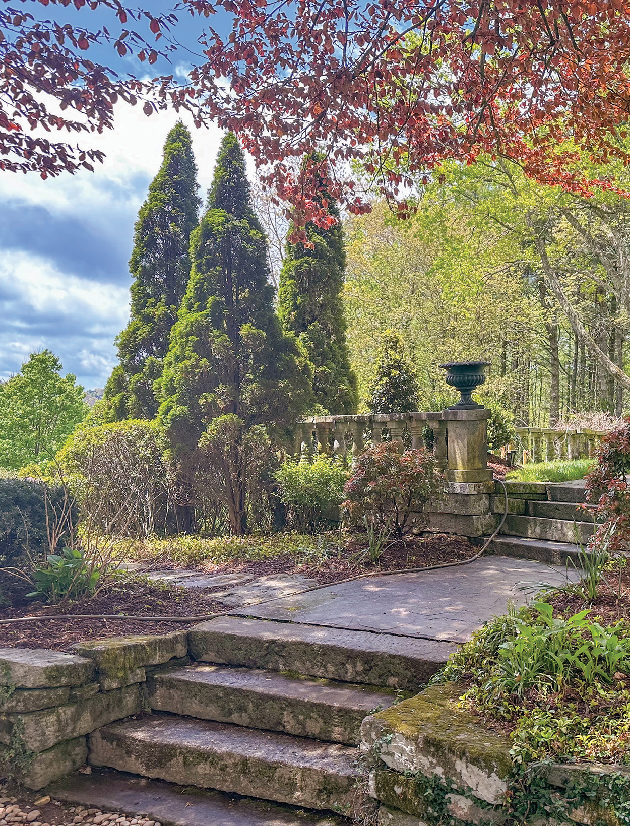 When Highlands Performing Arts Center stages its Satulah Mountain Home & Garden Tour, you can bet that it’ll be packed with entertainment and enlightenment. The tour, set for 10:00 A.M. to 3:00 P.M., Thursday, Friday, and Saturday, July 20-22 – will spotlight five stunning homes and gardens found on Historic Satulah Mountain, never before opened to the public. Tickets are available for the morning or afternoon and at $125 each. The last shuttle leaves PAC at 2:00 P.M. The homes represent a wide variety of architectural designs and interiors. The gardens are considered among the finest in the region, with mature native and introduced plant species. For instance, tour members will visit the home and gardens of Cathy Henson and Chris Carpenter, purchased in 2004. In 2005 they had the opportunity to purchase an adjacent parcel – the long-neglected gardens in the heart of the old historic district of Satulah Mountain created by New Orleans cotton broker Henry Worrell Sloan. Also included on the tour is Chetolah. Located on the western face of Satulah Mountain, it’s the original home of Henry Martin Bascom, the second mayor of Highlands. Built in 1892, this American Foursquare home was constructed on a three-acre lot purchased from his mother-in-law, Mrs. Amanda Davis. Between 1894 and 1916, Bascom purchased several adjoining lots, culminating in twenty acres of privacy and a near 360-degree view of the surrounding mountains. The American Foursquare design is meant to maximize floor space within a narrow footprint, which worked well in early urban neighborhoods and streetcar suburbs. That’s why Mayor Bascom’s Foursquare is so unique: a simple, urban design perched high on a mountain slope. Even more unique was Bascom’s inclusion of a wood-burning furnace in the basement. It was the first home in Highlands to have central heating. In 2018, Chetolah was rescued by the skill and vision of Highlands designer Darren Whatley and his spouse, David Moore. In a matter of months, they restored and updated the house while respecting the original design integrity of the home and by preserving the character and historical significance of Chetolah. If you’d like to tour these exclusive gardens and homes, sign up for the tour by visiting highlandsperformingarts.com or calling (828) 526-9047. Highlands PAC will offer shuttle service from its 507 Chestnut Street location – private cars will not be allowed. There will be golf carts available to anyone who needs assistance. Everyone should wear comfy, durable shoes. The event is sponsored by Bock Builders, MHK Architecture, Laurel Magazine, Suncoast Equity Management, and Berkshire Hathaway.
